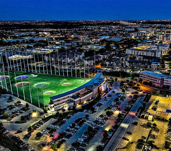 Modern view of The Domain in North Austin, Texas, featuring mid-rise buildings, bustling retail, and residential spaces surrounded by tree-lined streets and walkable urban design.