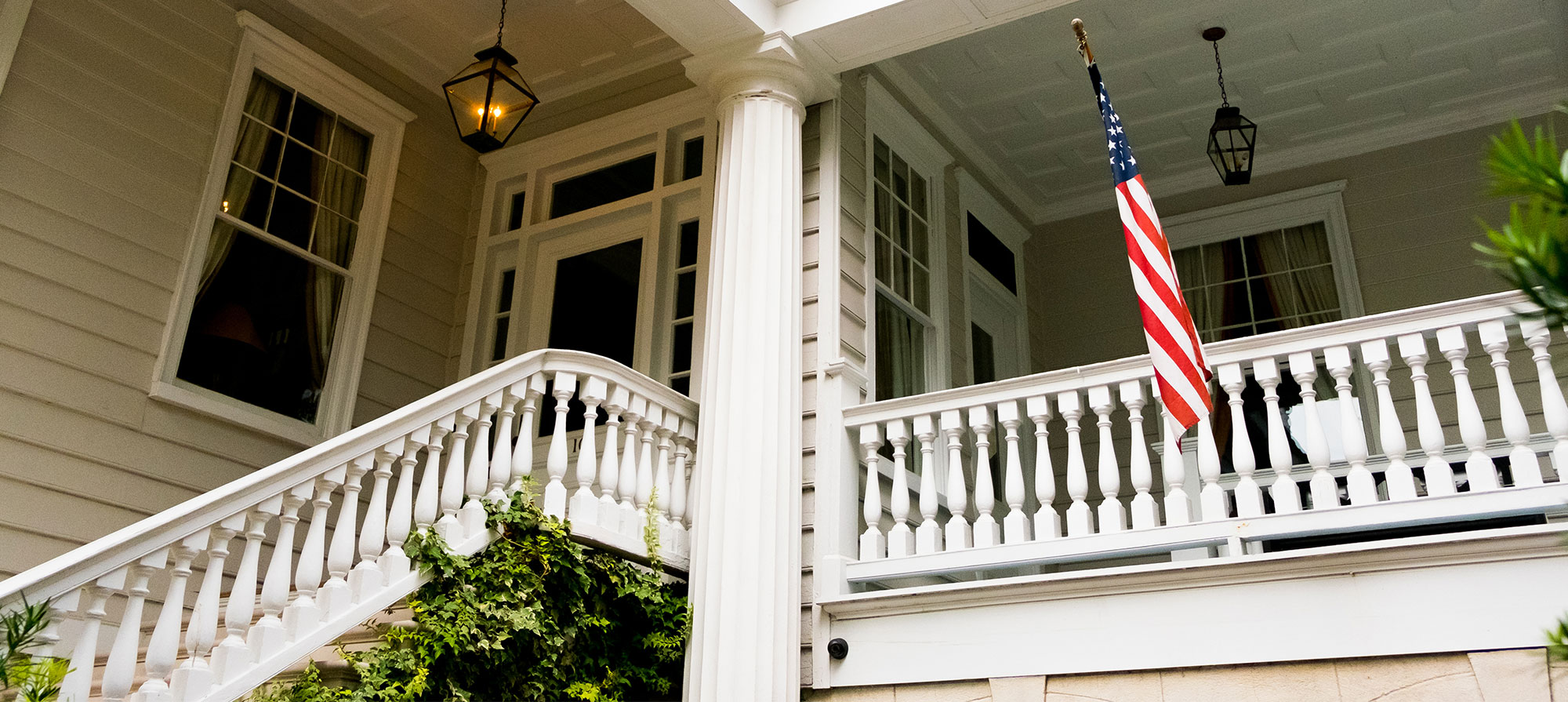 Historic home in Clarksville, Austin, Texas, featuring a white columned porch, lantern lighting, and traditional Southern architectural details.